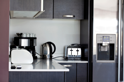 A bright, modern kitchen with a stainless steel refrigerator & ice maker