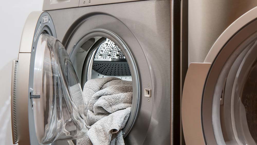 A clothes dryer, filled with freshly-dried towels