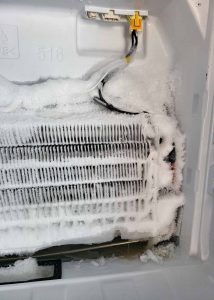 Freezer with ice built up on coils