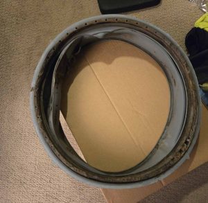 Old, damaged door seal removed from an Electrolux washing machine