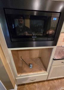 Hole in a cabinet, prepped for the installation of a Samsung wall oven